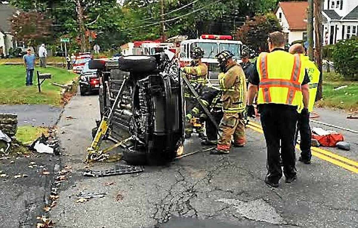 A woman was rescued after her car flipped over on Charles Street in Torrington early Wednesday afternoon. She suffered minor injuries and the road was closed for a short time.