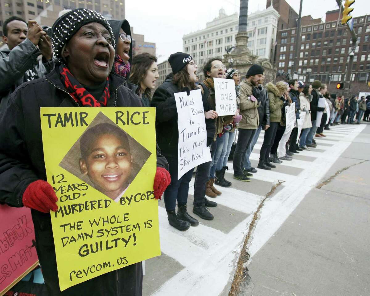 In this Nov. 25, 2014 photo, demonstrators block Public Square in Cleveland, during a protest over the police shooting of Tamir Rice. The city of Cleveland has reached a settlement April 25, 2016 in a lawsuit over the death of Rice, a black boy shot by a white police officer while playing with a pellet gun.