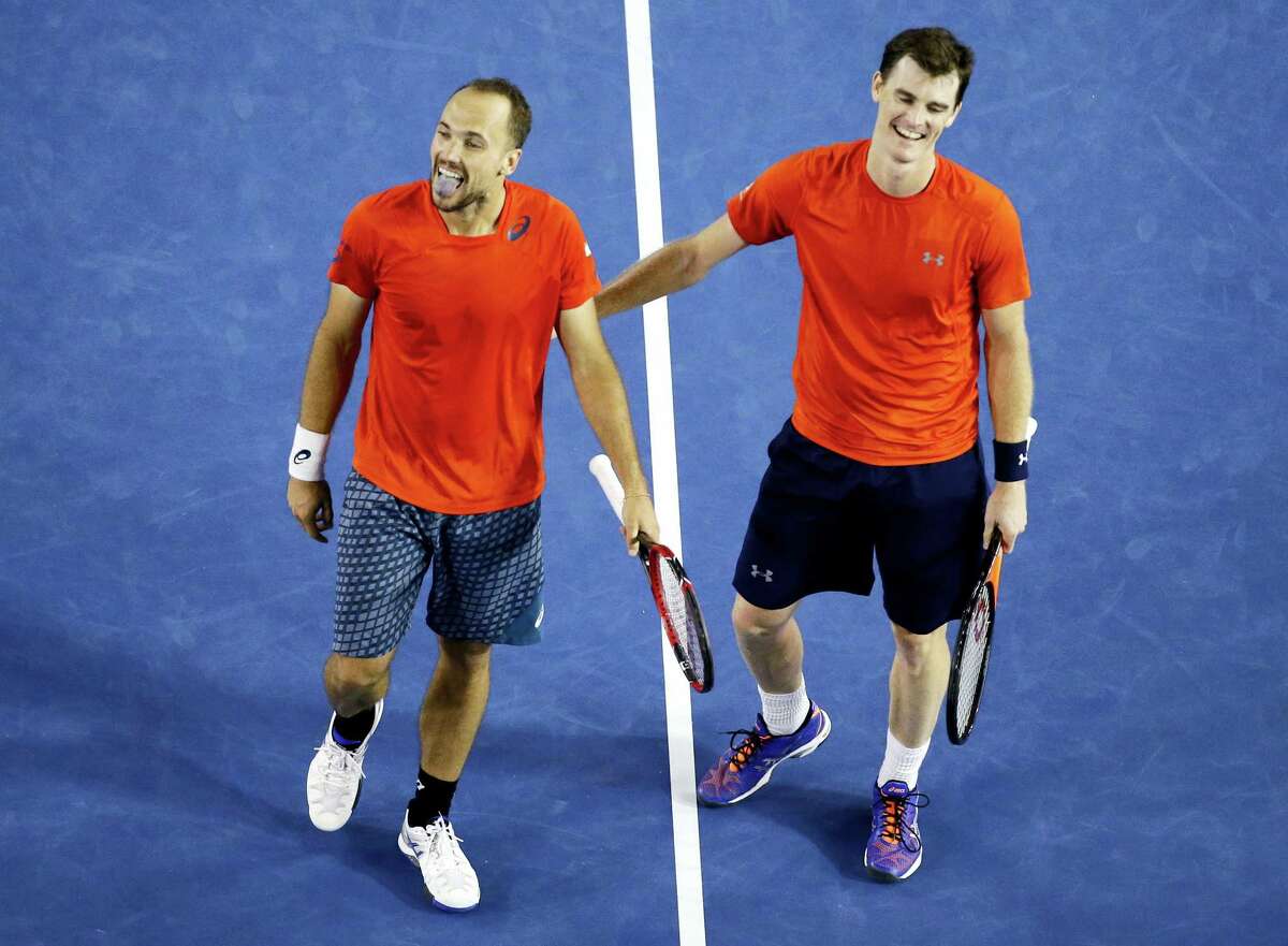 Jamie Murray, right, of Britain and Bruno Soares of Brazil celebrate after defeating Daniel Nestor of Canada and Radek Stepanek of the Czech Republic in the men's doubles final at the Australian Open tennis championships in Melbourne, Australia, early Sunday, Jan. 31, 2016.(AP Photo/Vincent Thian)