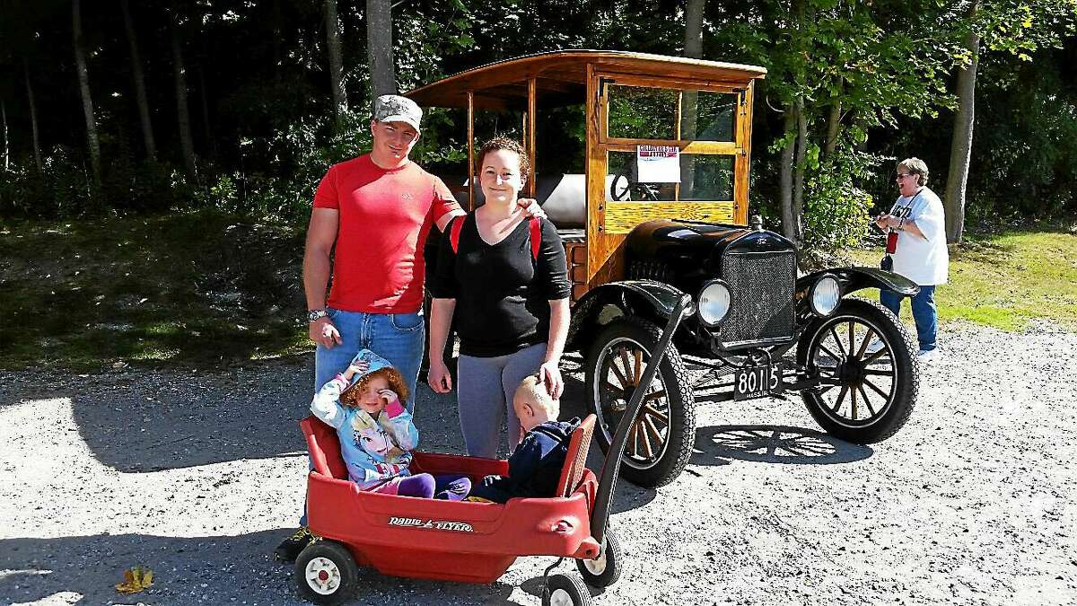 N.F. Ambery photo Tim and Elyse Raymond of Plainville pause with their children Kelly, 4, and Blake, 2, in front of an oak-wood-paneled 1923 Ford Model T Beach Wagon at the Third Annual Classic Community Vintage Vehicle Show.