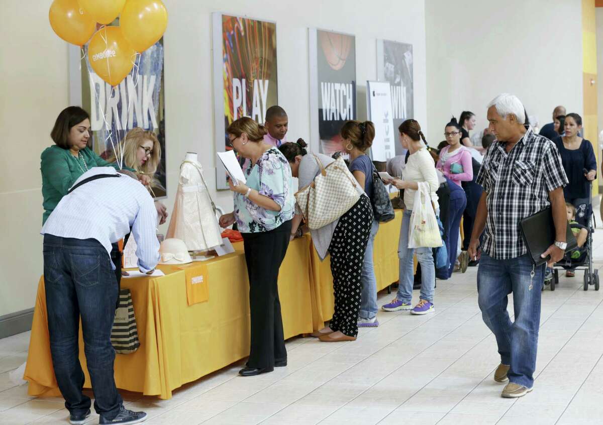 In this Tuesday, Oct. 6, 2015, file photo, job applicants fill out forms during a job fair at Dolphin Mall in Miami. On Thursday, Sept. 29, 2016, the Labor Department reports on the number of people who applied for unemployment benefits the week before.