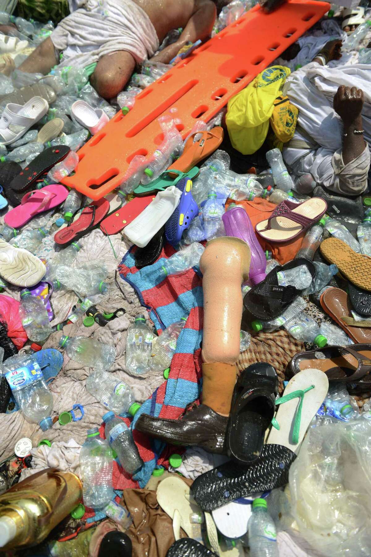 In this picture taken Thursday, Sept. 24, 2014, bodies of people crushed in Mina, Saudi Arabia during the annual hajj pilgrimage, are seen amongst belongings and empty water bottles. Hundreds were killed and injured, Saudi authorities said. The crush happened in Mina, a large valley about five kilometers (three miles) from the holy city of Mecca that has been the site of hajj stampedes in years past.