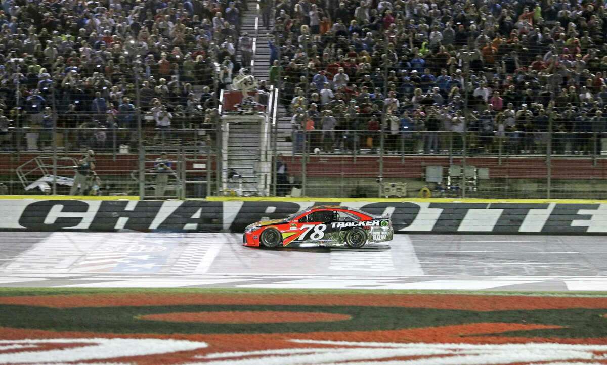 Martin Truex Jr takes the checkered flag to win Coca-Cola 600 at Charlotte Motor Speedway on Sunday.