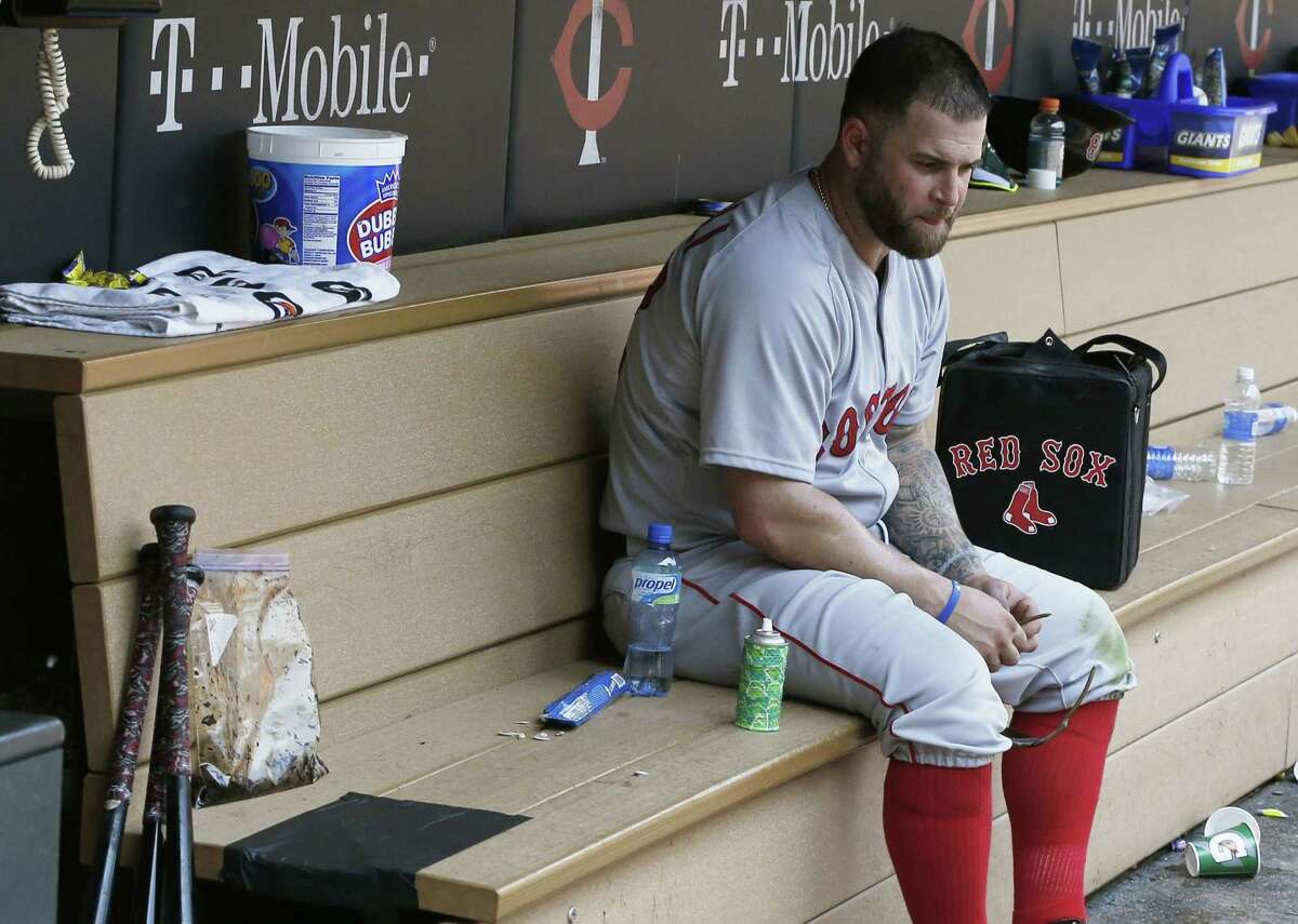 Boston first baseman Mike Napoli sits alone in the dugout after the Minnesota Twins beat the Red Sox 6-4 on Wednesday in Minneapolis.