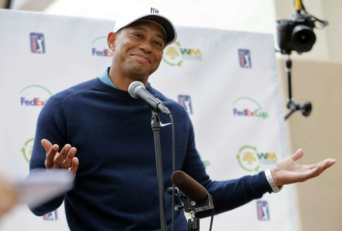 Tiger Woods gestures as he talks to the media after playing a practice round at the Phoenix Open Tuesday in Scottsdale, Ariz.