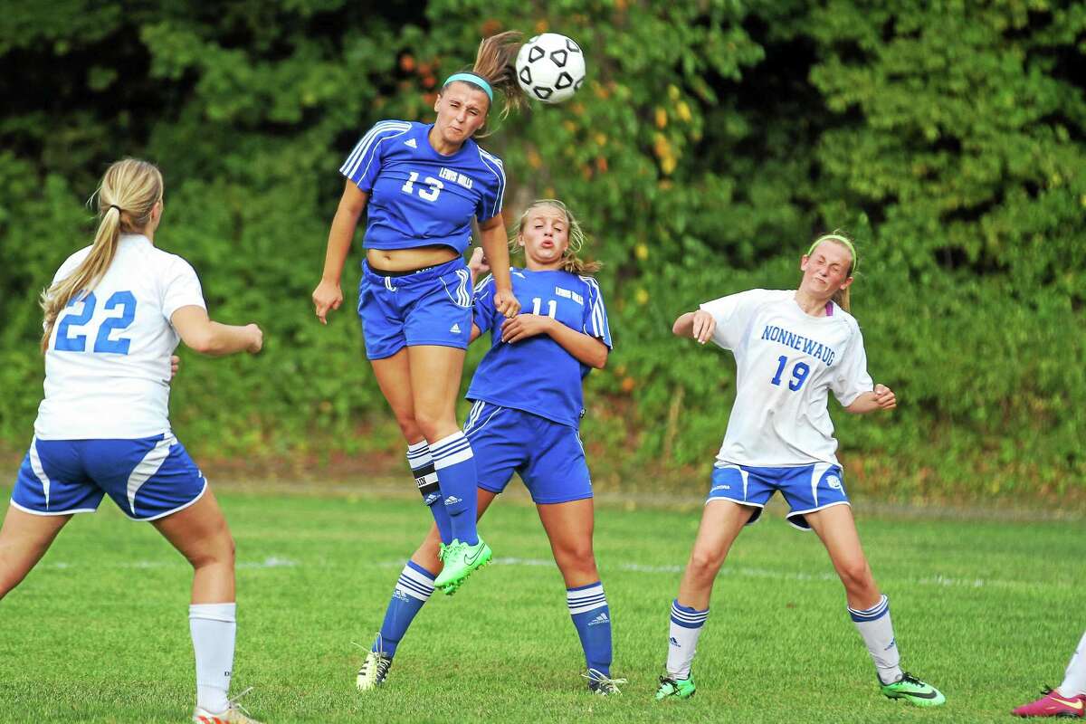 Senior captain Maddie Murdick of Lewis Mills heads the ball in her team’s win over Nonnewaug.