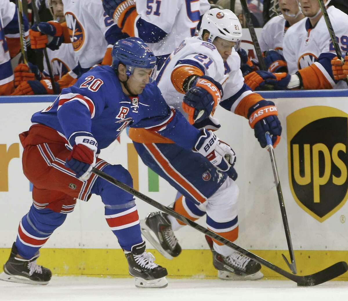 Rangers left wing Chris Kreider (20) fends off New York Islanders right wing Kyle Okposo (21) during a Jan. 13 game at Madison Square Garden in New York.