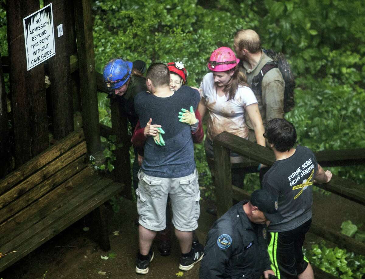 Tour guide Peggy Nims hugs a friend after she made it out of Hidden River Cave on Thursday, May 26, 2106, after 18 people on a cave tour were trapped due to flash flood waters in Horse Cave, Kentucky.