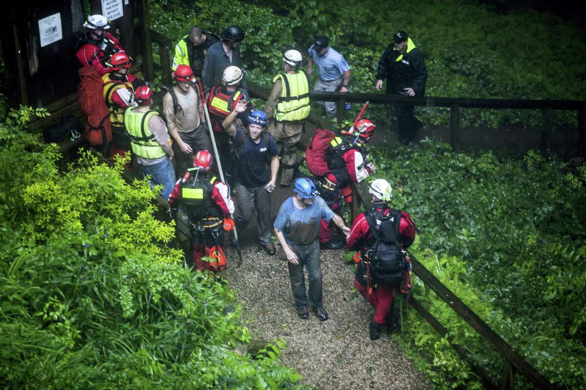 People who were rescued from Hidden River Cave exit the cave on Thursday, May 26, 2106, after 18 people on a cave tour were trapped due to flash flood waters in Horse Cave, Kentucky.