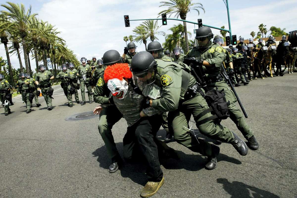 Orange County Sheriff’s deputies take a protester into custody outside the Anaheim Convention Center where Republican presidential candidate Donald Trump held a rally, Wednesday, May 25, 2016, in Anaheim, Calif.