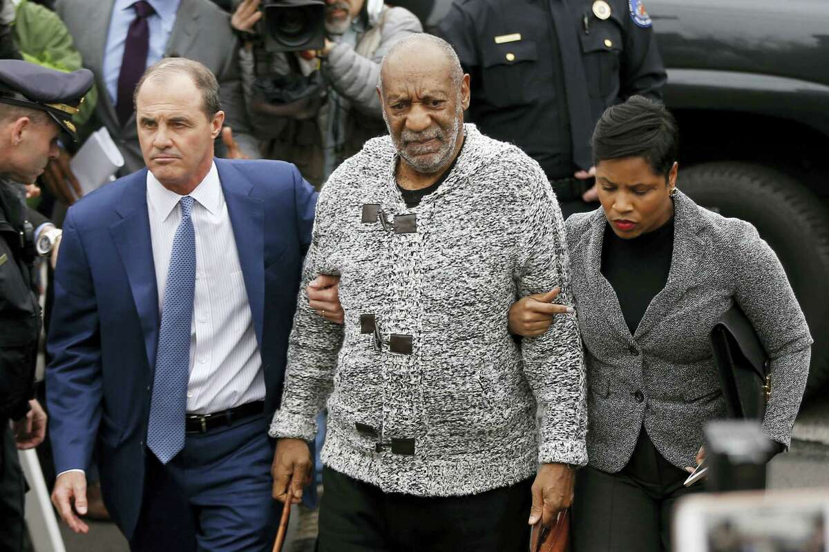 In this Wednesday, Dec. 30, 2015 photo Bill Cosby, center, accompanied by his attorneys Brian McMonagle, left, and Monique Pressley, arrives at court in Elkins Park, Pa.