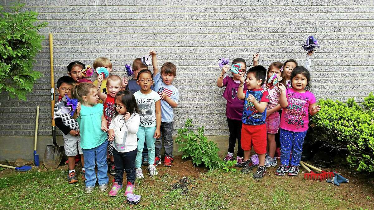 Students at Head Start-Forest Court stand around a newly planted rose bush in honor of the program’s 50 year anniversary.
