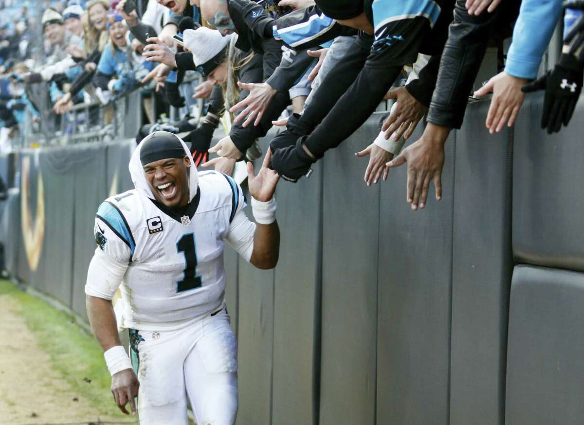 Panthers quarterback Cam Newton (1) celebrates with fans after beating the Seahawks on Sunday.