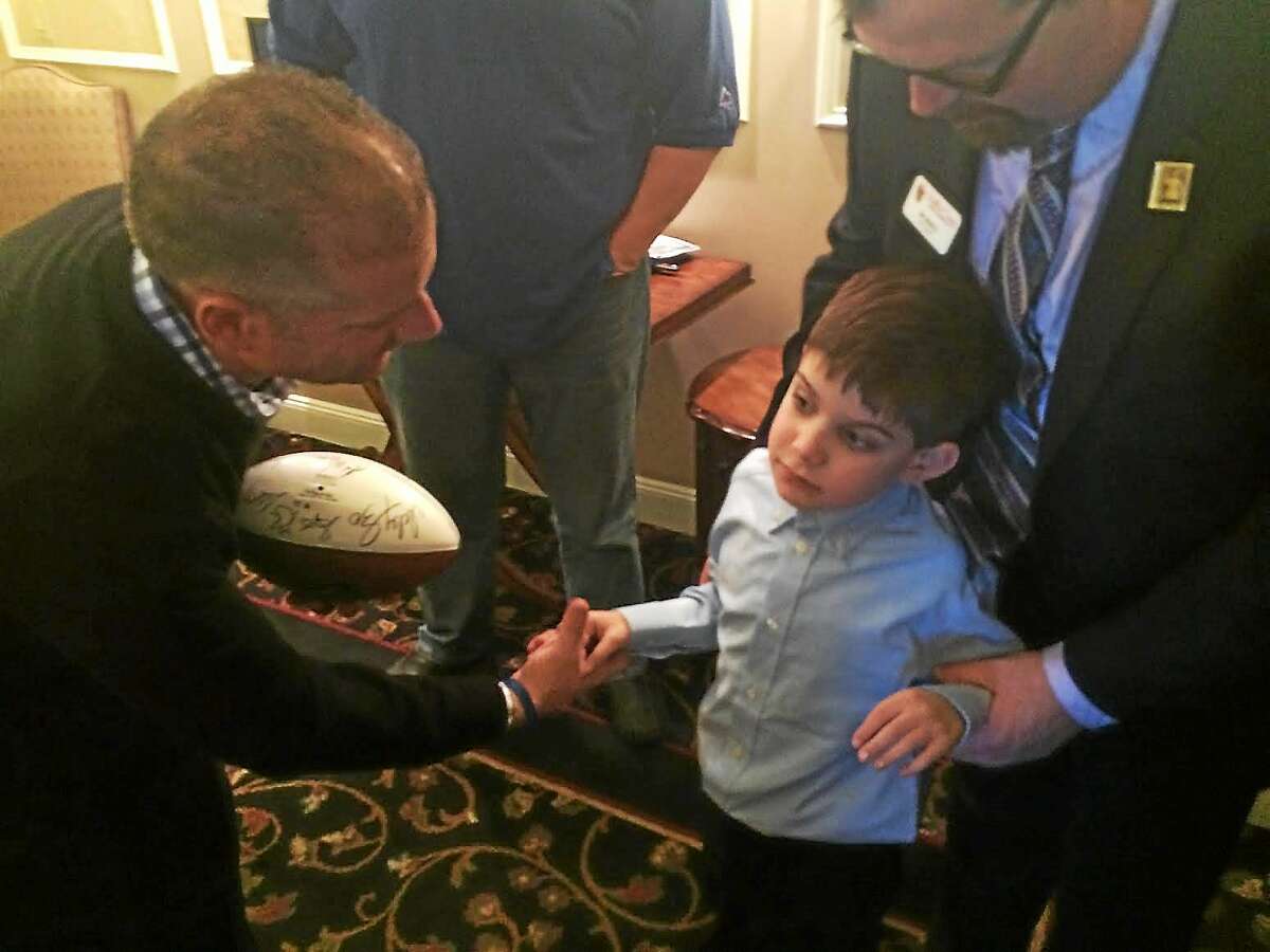 Walter Camp’s Generation UCAN Inspire Award Winner Dante Chiappetta shakes hands with his father, Joe, at the Walter Camp Weekend Breakfast of Champions at Anthony’s Ocean View on Saturday morning.