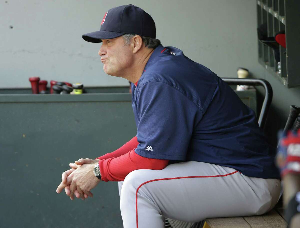 Red Sox manager John Farrell sits in the dugout during the eighth inning Sunday.