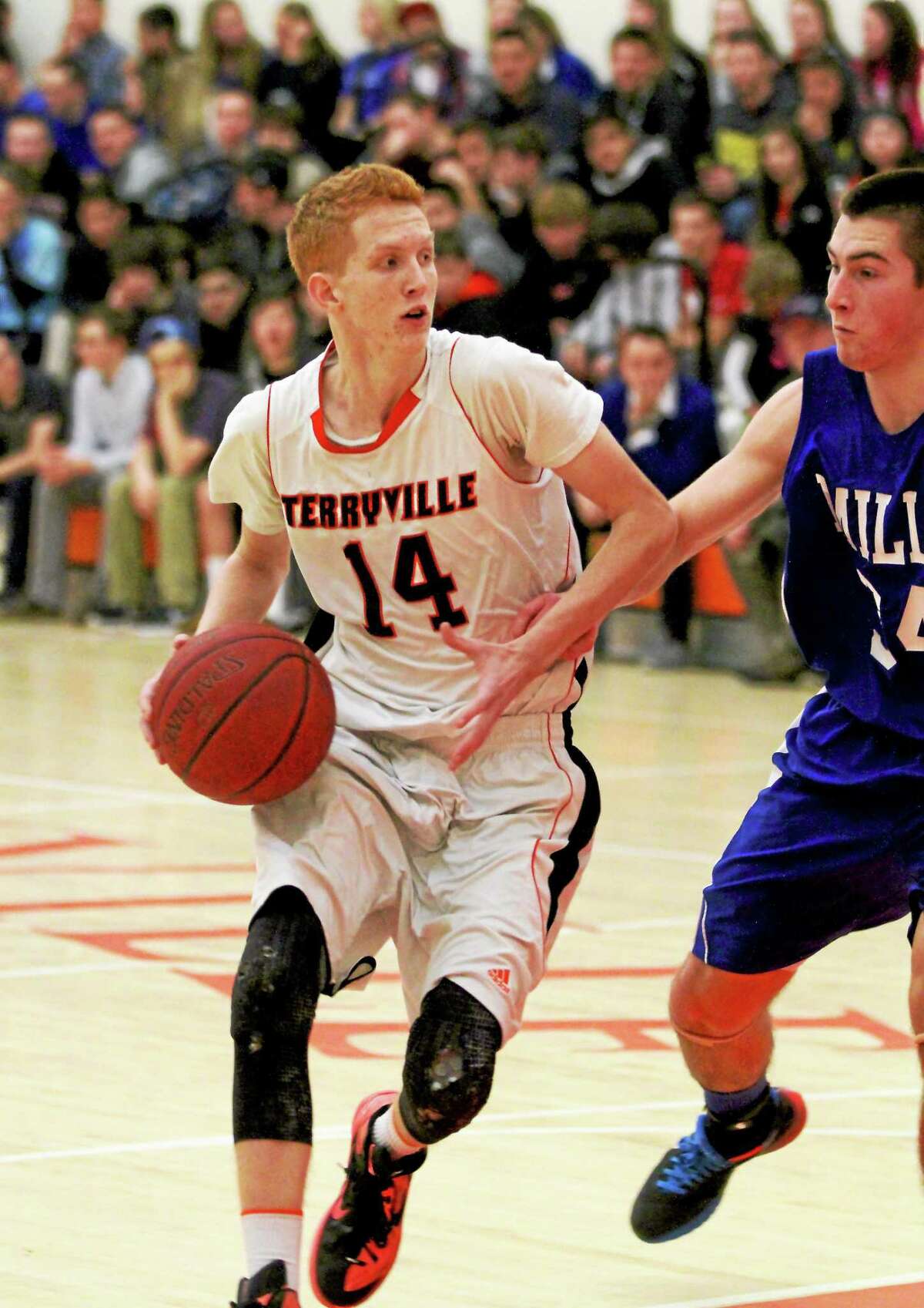 Terryville’s Shea Tracy looks to pass in his team’s win over Lewis Mills Thursday night.