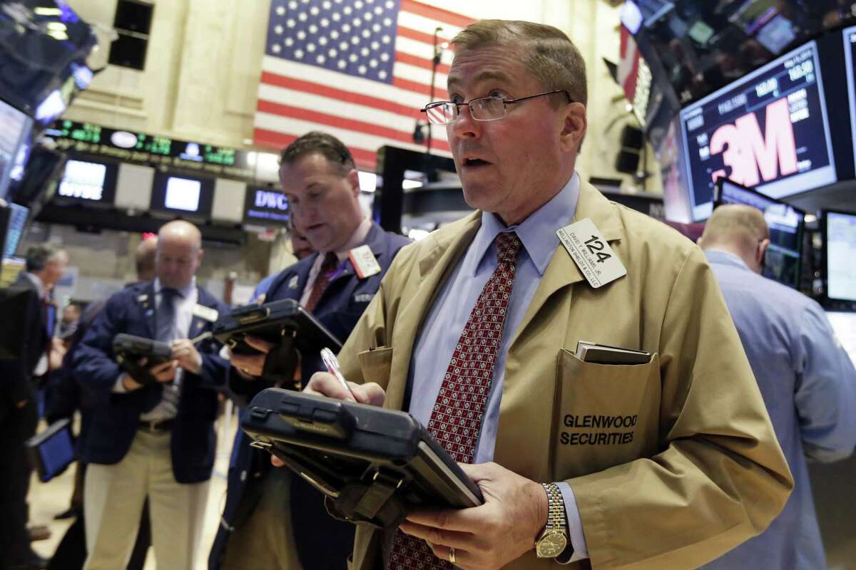 Trader David Williams, right, works on the floor of the New York Stock Exchange Friday.