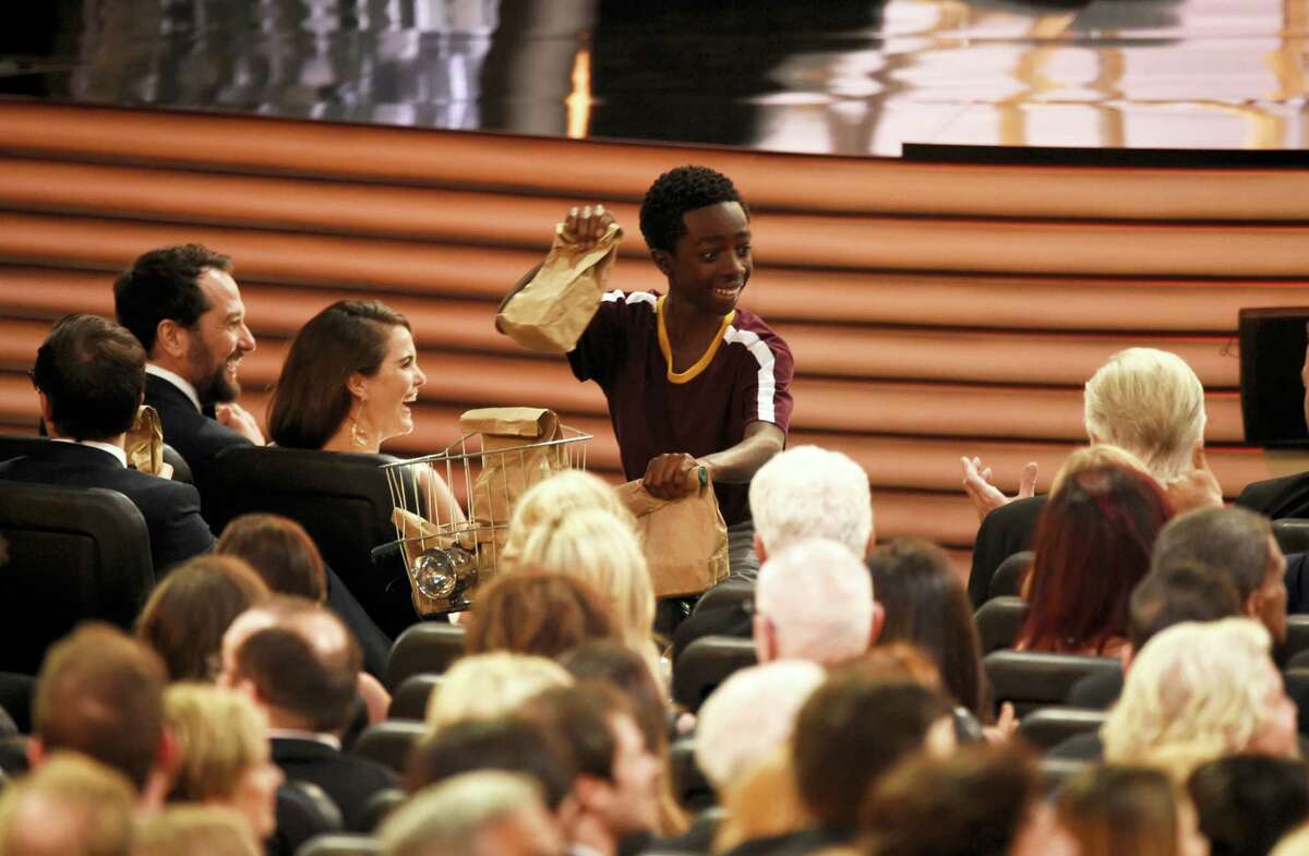 Caleb McLaughlin distributes sandwiches at the 68th Primetime Emmy Awards on Sunday, Sept. 18, 2016 at the Microsoft Theater in Los Angeles.
