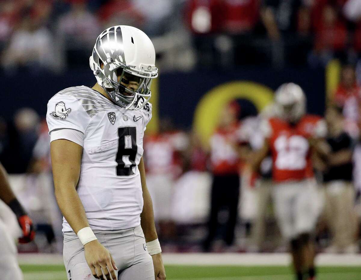 Oregon’s Marcus Mariota walks off the field during the second half of the college football national championship game against Ohio State on Monday in Arlington, Texas.