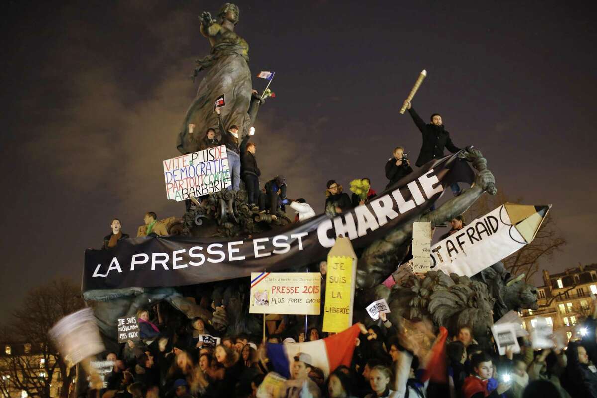 Hundreds of thousands of people marched through Paris on Sunday in a massive show of unity and defiance in the face of terrorism that killed 17 people in France’s bleakest moment in half a century. Banner reads: Press is Charlie.