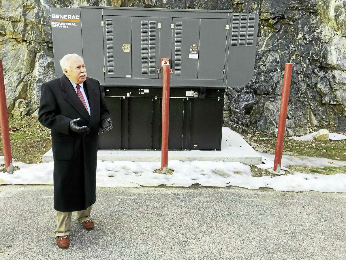 Northwest Senior Housing Corporation president Larry Hannafin speaks Monday, as a newly-installed generator at the Susan M.B. Perry Senior Housing complex is celebrated.