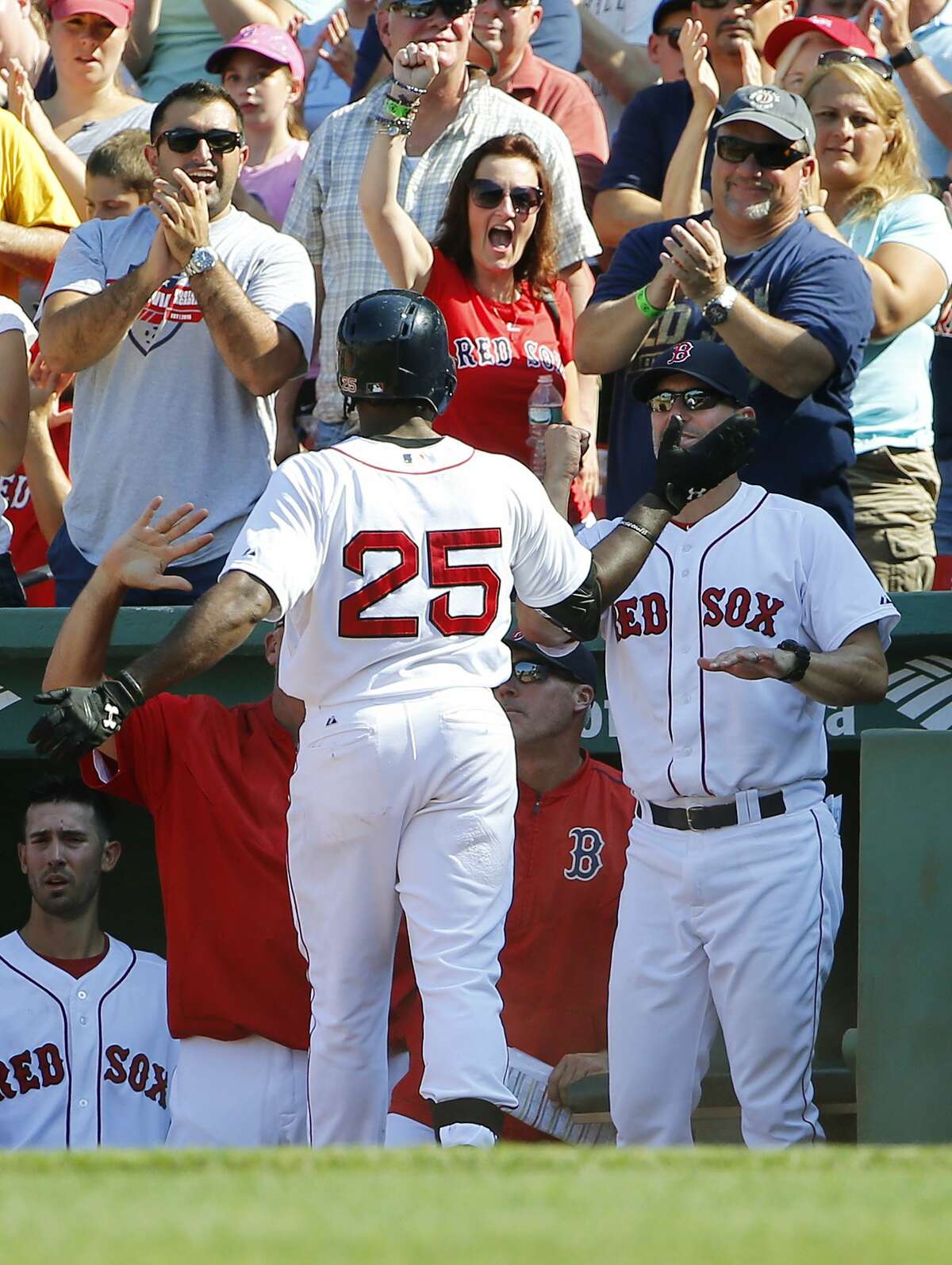 Fans cheer as Red Sox outfielder Jackie Bradley Jr. (25) is congratulated by interim manager Torey Lovullo after hitting a two-run home run against the Toronto Blue Jays Monday at Fenway Park in Boston.