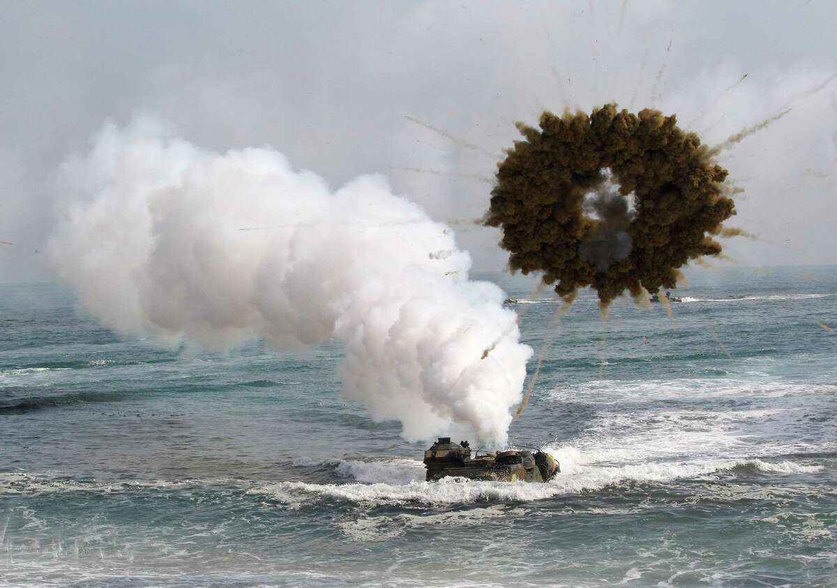 FILE - In this March 31, 2014 file photo, a South Korean marine LVT-7 landing craft sails to shores through a smoke screen during the U.S.-South Korea joint landing exercises, called Ssangyong, part of the Foal Eagle military exercises, in Pohang, South Korea. North Korea has told the United States that itís willing to impose a temporary moratorium on nuclear tests if Washington scraps planned military drills with South Korea this year, the Northís official news agency said Saturday, Jan. 10, 2015. The U.S. has previously refused to cancel military drills with South Korea, even at times of high tension and has said the North must first demonstrate how serious it is about nuclear disarmament before serous talks can resume. (AP Photo/Ahn Young-joon, File)