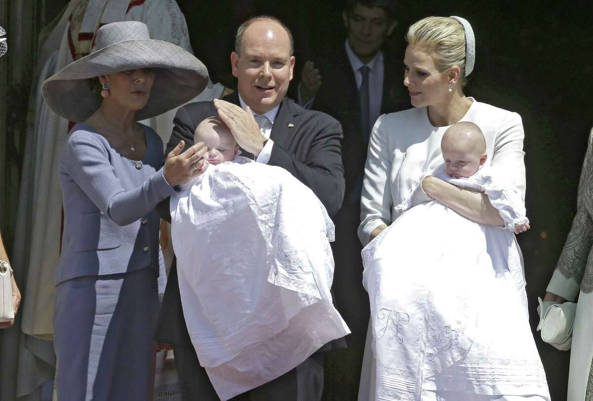 Prince Albert II of Monaco, centre, poses with his sister Princess Caroline of Hanover, as she protects Princess Gabriella from the sun, as his wife Princess Charlene holds Prince Jacques, right, after their baptism ceremony in the Cathedral of Monaco, Sunday, May 10, 2015, in Monaco. Monaco's newest royals Prince Jacques Honore Rainier and Princess Gabriella Therese Marie were christened at a ceremony in Monaco on Sunday. Crowds turned out in their thousands to catch a glimpse of the twins and their parents Prince Albert II and Princess Charlene. (AP Photo/Lionel Cironneau)