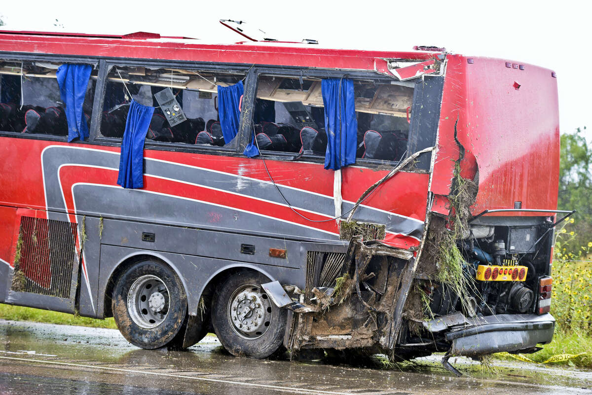 A damaged OGA Charters bus is hauled away after a fatal rollover on Saturday, May 14, 2016, south of the Dimmit-Webb County line on U.S. 83 North in Texas.