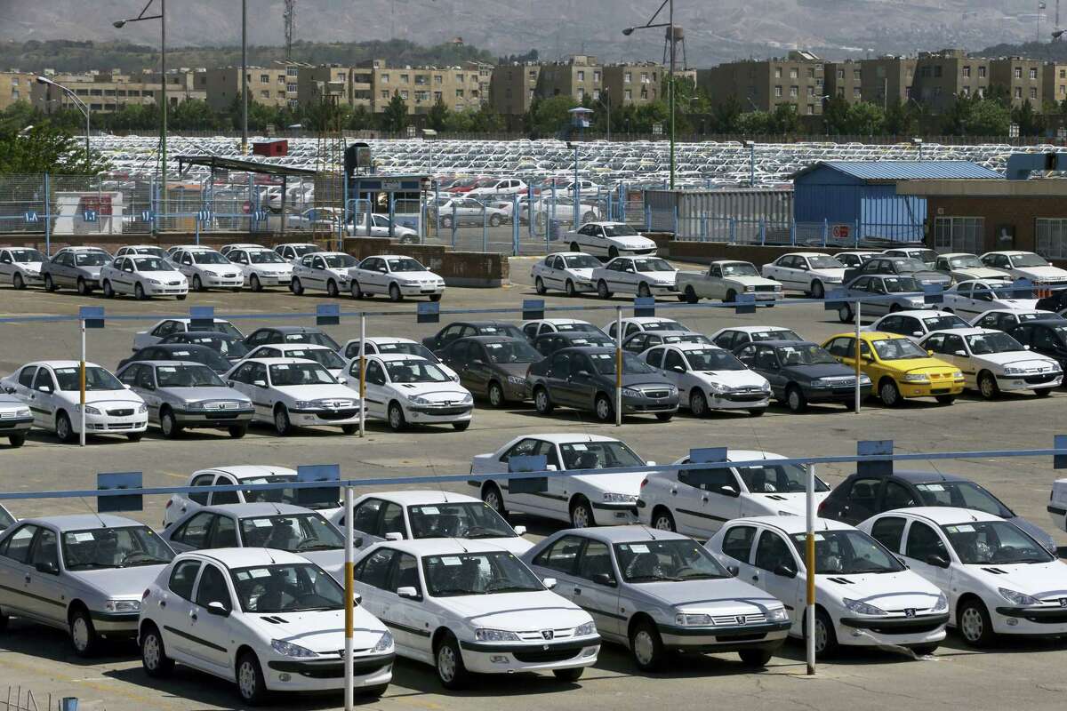 Cars are parked in a depot at the state-run Iran Khodro automobile manufacturing plant, just outside Tehran, Iran.