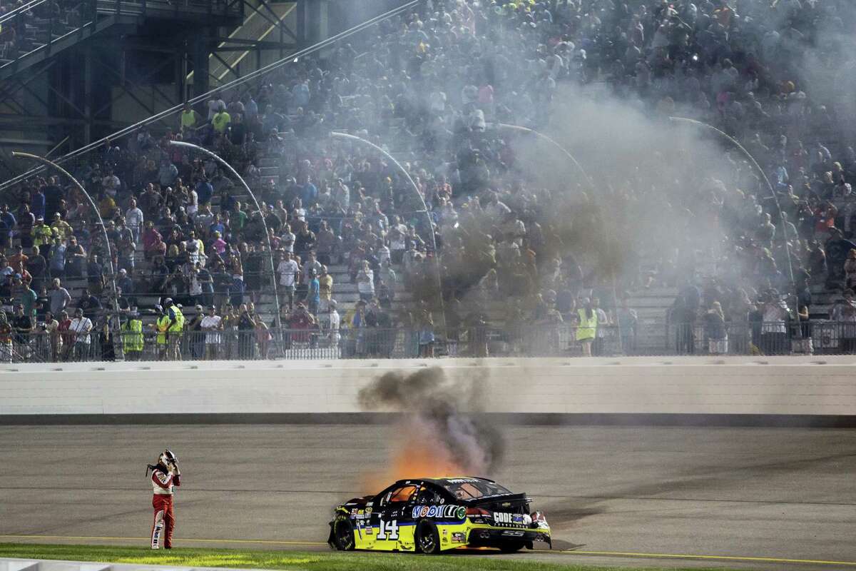 Tony Stewart watches his car burn after crashing during Saturday’s race at Richmond International Raceway.