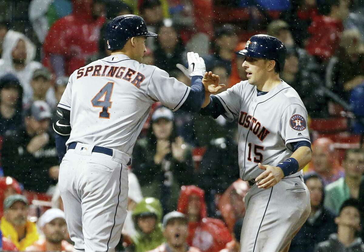The Astros’ George Springer, left, celebrates his two-run home run during the sixth inning on Friday.