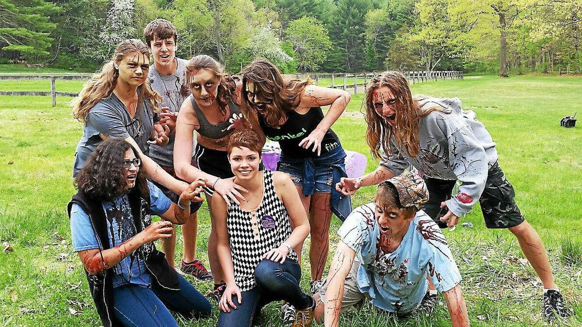 Shepaug Valley High School senior Krista Collins, 17, of Washington poses with volunteers wearing zombie costumes prior to the 5K Zombie Run Against Epilepsy on Saturday afternoon at Steep Rock Preservation at 2 Tunnel Road in Washington Depot.