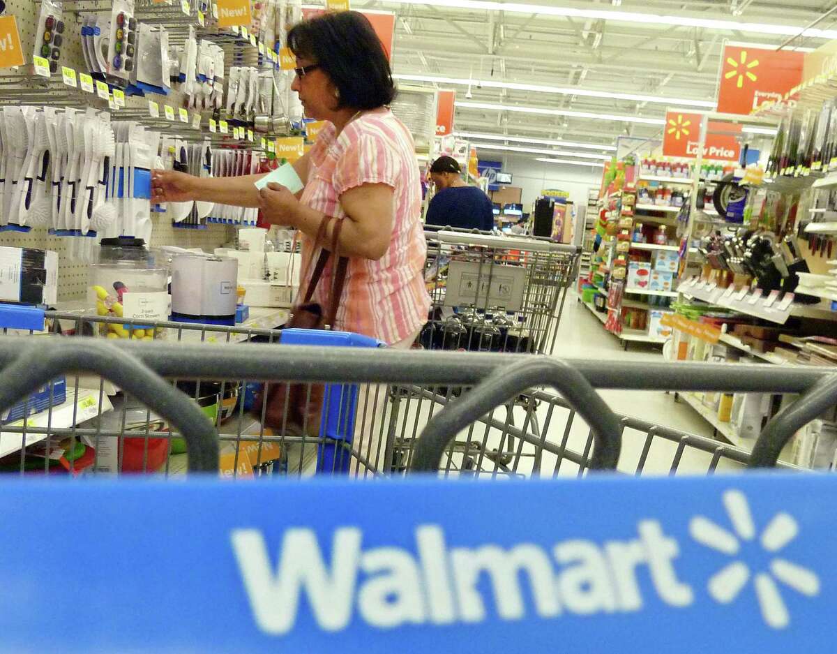 AP Photo/Elise Amendola Shoppers look at merchandise at Walmart in Danvers, Mass.