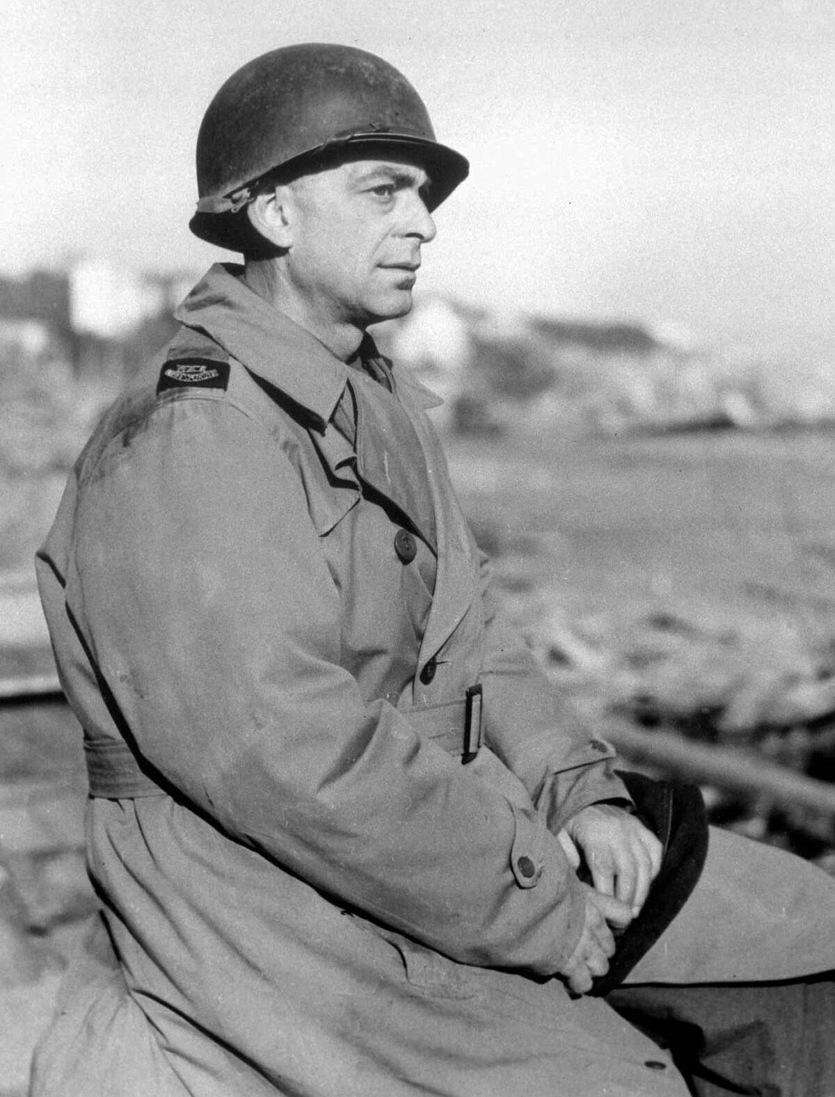 In this March 1, 1944, photo, Ed Kennedy, chief of The Associated Press staff in North Africa, wears a metal helmet at the Anzio beachhead in Italy.