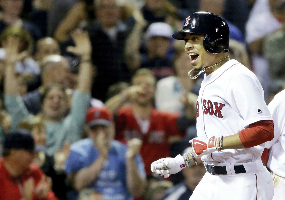Boston Red Sox's Mookie Betts celebrates after hitting a three-run homer against the Houston Astros in the sixth inning of a baseball game at Fenway Park, Thursday, May 12, 2016, in Boston. (AP Photo/Elise Amendola)