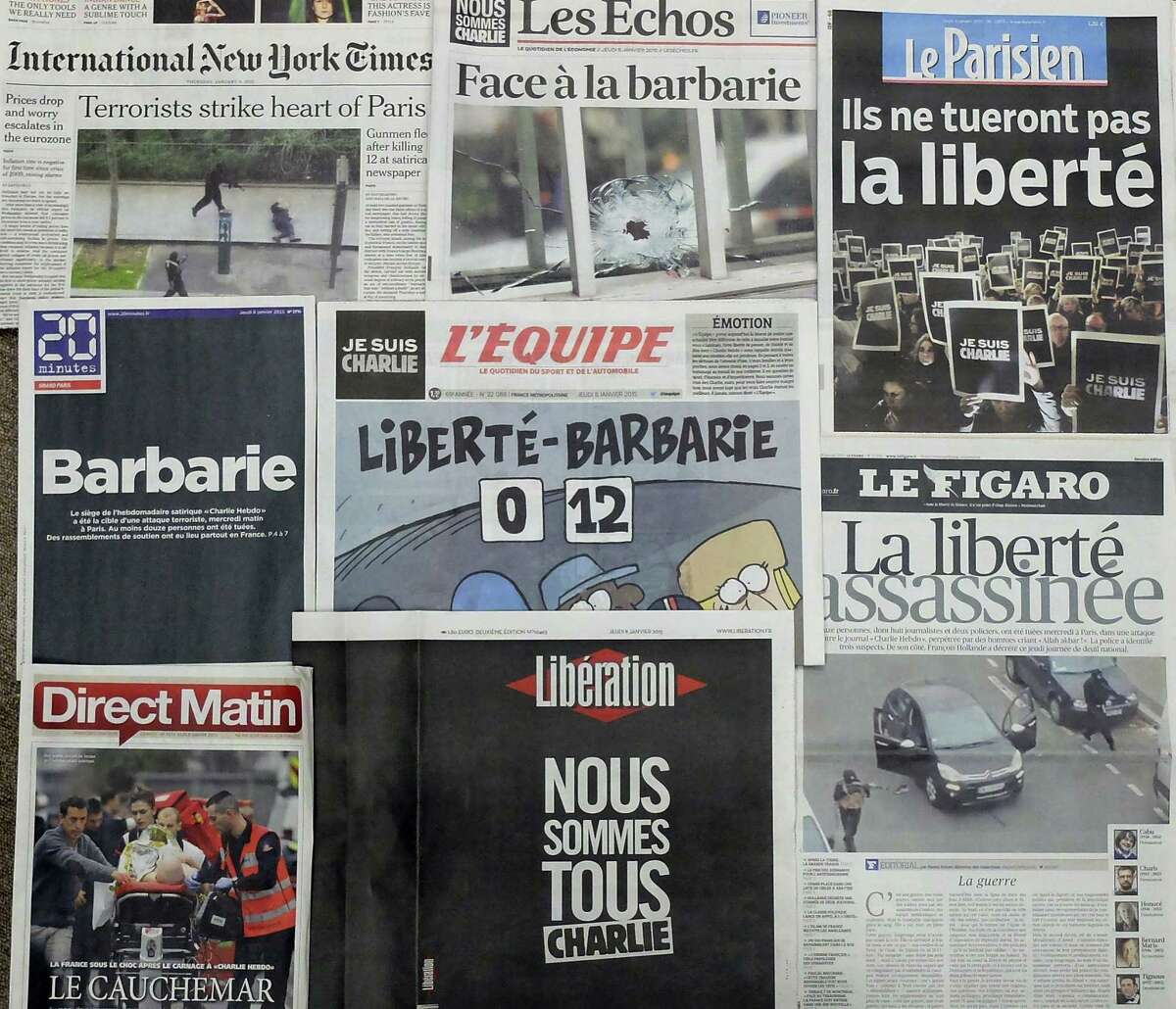 Frontpages of French newspapers reporting about Wednesday's attack on a satirical newspaper in Paris are displayed in Paris Thursday, Jan. 8, 2015. Police hunted Thursday for two heavily armed men, one with possible links to al-Qaida, in the methodical killing of 12 people at the Charlie Hebdo that caricatured the Prophet Muhammed. The prime minister said the possibility of a new attack "is our main concern" and announced several overnight arrests. (AP Photo/Bertrand Combaldieu)