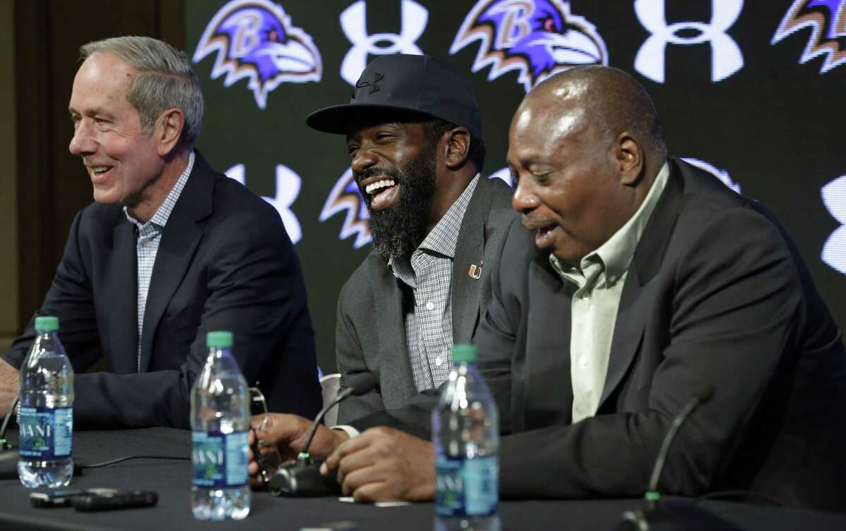 Baltimore Ravens safety Ed Reed, center, laughs at a Thursday news conference while announcing his retirement alongside team president Dick Cass, left, and general manager and executive vice president Ozzie Newsome in Owings Mills, Md.
