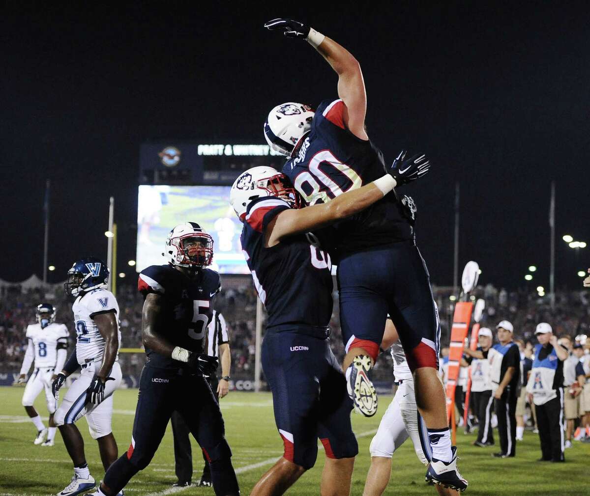 UConn tight end Tommy Myers, right, celebrates with Alec Bloom (86) after scoring a touchdown during the first half Thursday.