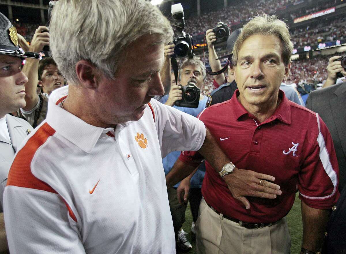 In this 2008 file photo, Clemson coach Tommy Bowden, left, congratulates Alabama coach Nick Saban after No. 24 Alabama beat No. 9 Clemson 34-10 at the Georgia Dome in Atlanta.