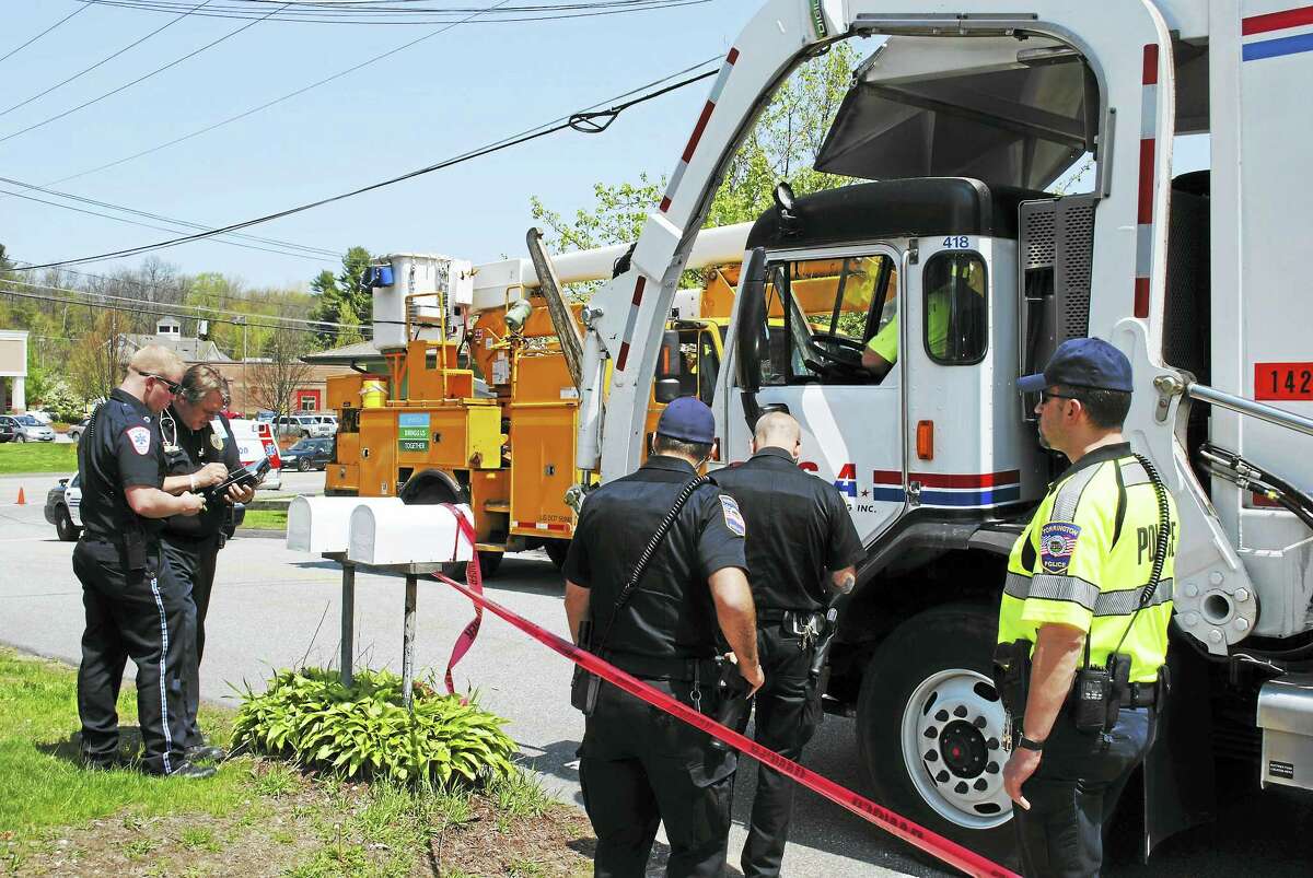 Greenridge Road in Torrington was shut down briefly on Thursday after a recycling truck hit a utility pole and live wires landed on his truck. There were no injuries reported.