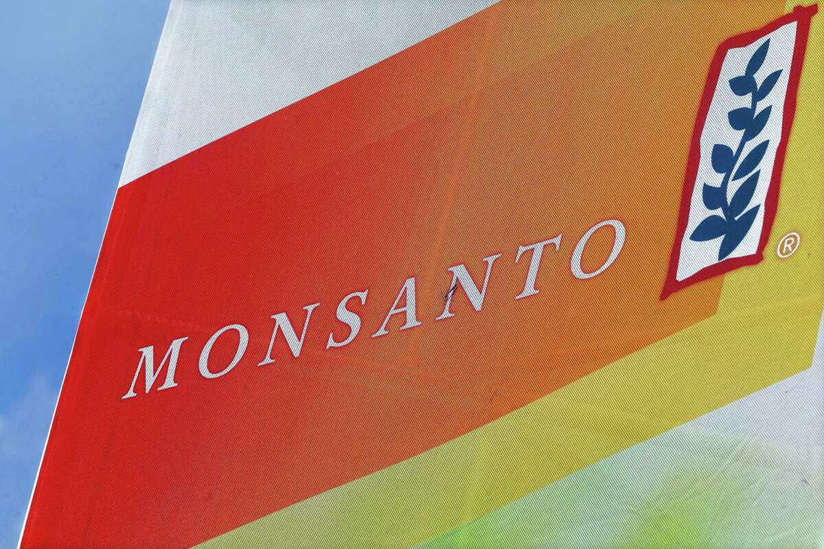 This Aug. 31, 2015 photo, shows the Monsanto logo on display at the Farm Progress Show in Decatur, Ill. German drug and farm chemical company Bayer AG said it signed a deal Wednesday, Sept. 14, 2016 to acquire seed and weed-killer company Monsanto for about $66 billion in cash.
