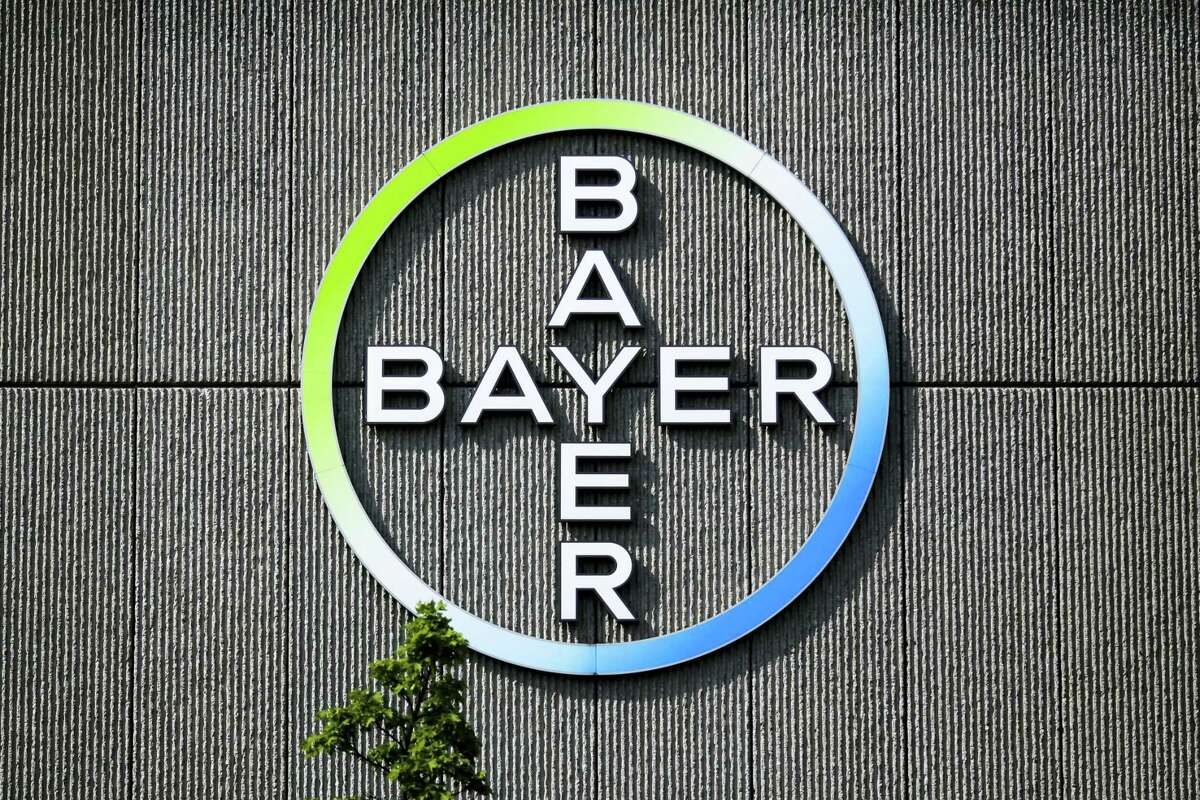 In this May 23, 2016 picture the Bayer AG corporate logo is displayed on a building of the German drug and chemicals company in Berlin, Germany. German drug and farm chemical company Bayer AG said it signed a deal Wednesday, Sept. 14, 2016 to acquire seed and weed-killer company Monsanto for about $66 billion in cash.
