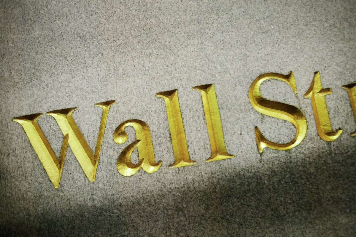 FILE - This Oct. 8, 2014, file photo, shows a Wall Street address carved in the side of a building, in New York. World stocks rose Thursday, Sept. 3, 2015, as a holiday in China gave investors a break from its torrid markets and the European Central Bank was expected to confirm its willingness to provide more stimulus to the eurozone, if needed.