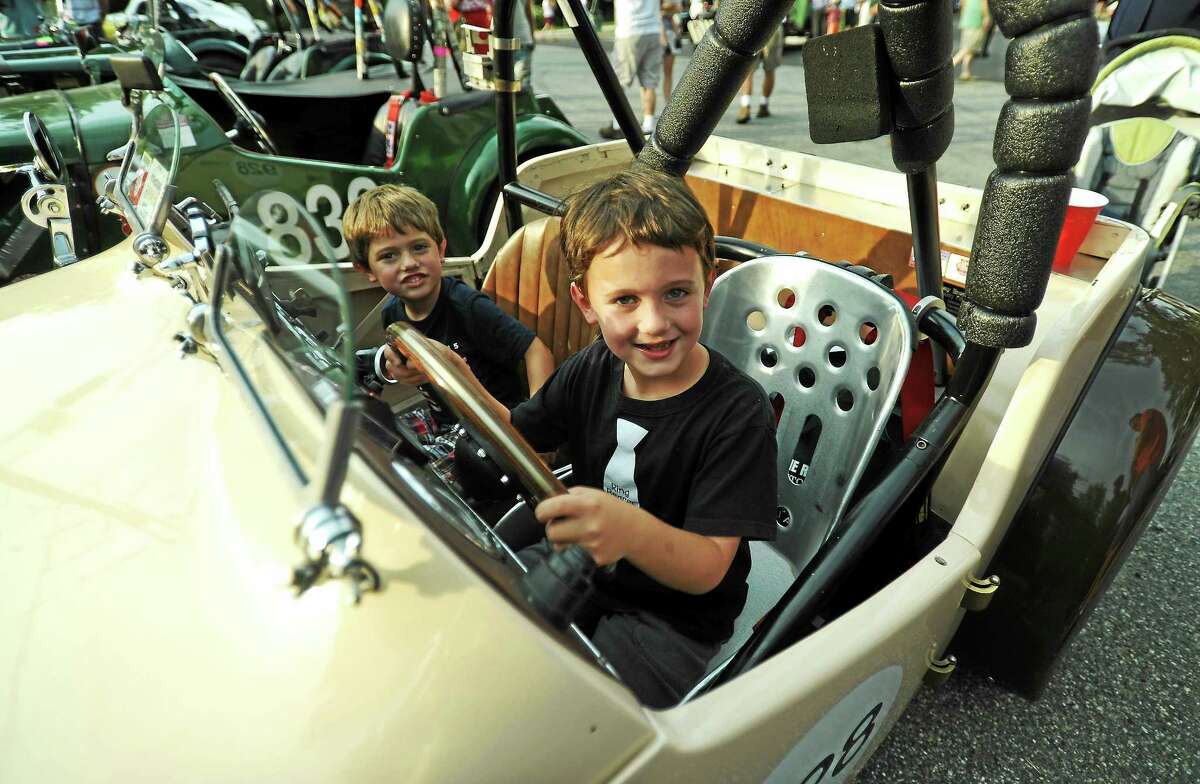 From left, Rowan Nelson, 4, and Finley Nelson, 7, of Kinderhook, New York, checks out Frank Filangeri’s 1951 MG-TD.