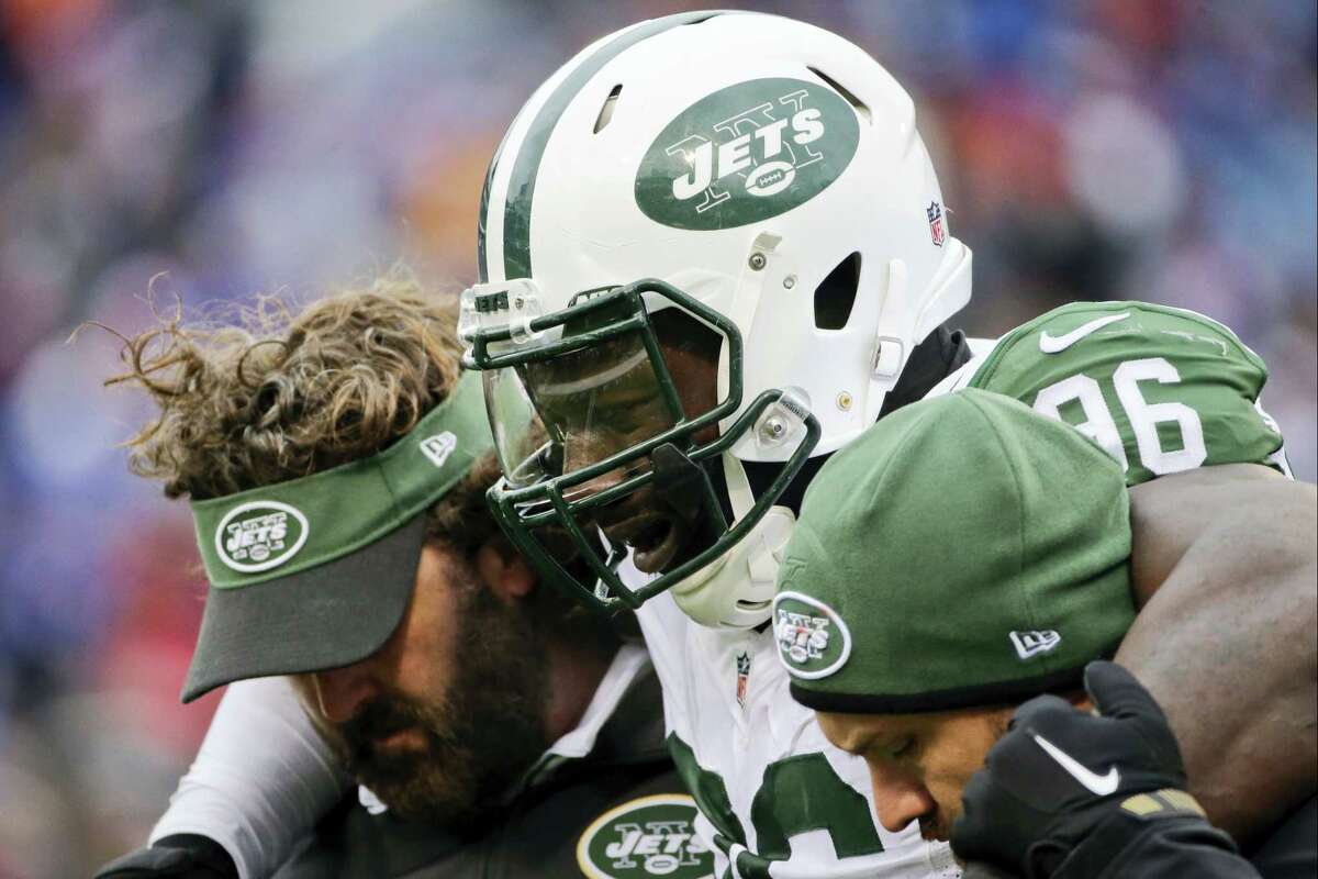 New York Jets defensive end Muhammad Wilkerson (96) is helped off the field after being hurt on a play during the second half of an NFL football game against the Buffalo Bills Sunday, Jan. 3, 2016, in Orchard Park, N.Y. (AP Photo/Bill Wippert)