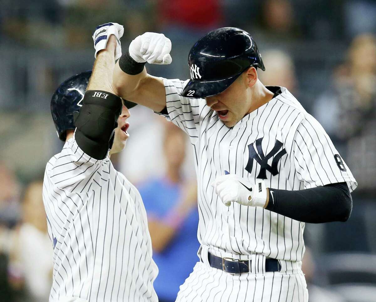 New York’S Brett Gardner, left, celebrates with pinch-hitter Jacoby Ellsbury after Ellsbury’ seventh-inning solo home run Tuesday night. The Yankees shut out the Dodgers 3-0.