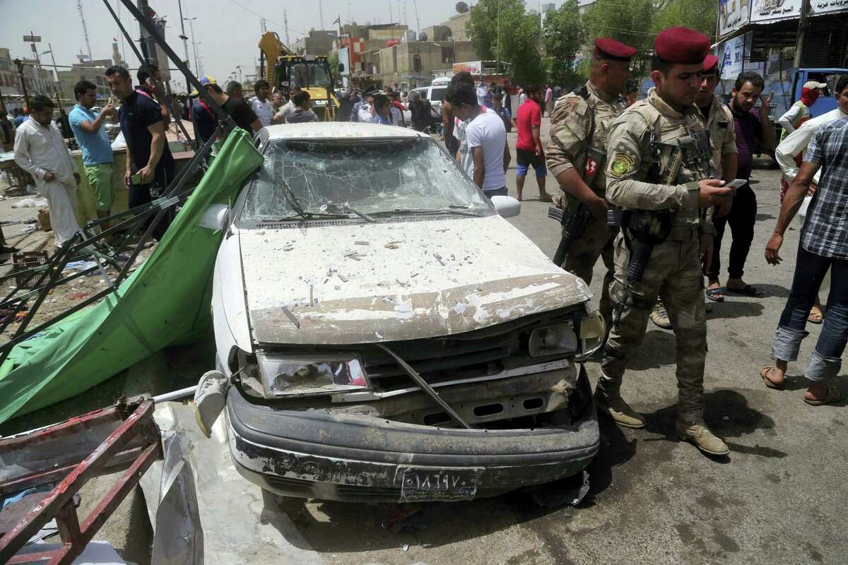 Security forces and citizens inspect the scene after a car bomb explosion at a crowded outdoor market in the Iraqi capital’s eastern district of Sadr City, Iraq, Wednesday, May 11, 2016. An explosives-laden car bomb ripped through a commercial area in a predominantly Shiite neighborhood of Baghdad on Wednesday, killing and wounding dozens of civilians, a police official said.