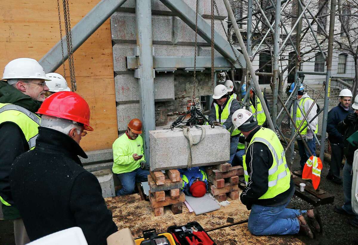 Massachusetts officials work Dec. 11 to remove a time capsule in the cornerstone of the Statehouse in Boston. Secretary of State William Galvin says the 200-year-old time capsule is believed to contain items such as old coins and newspapers, but the condition of the contents isnít yet known.