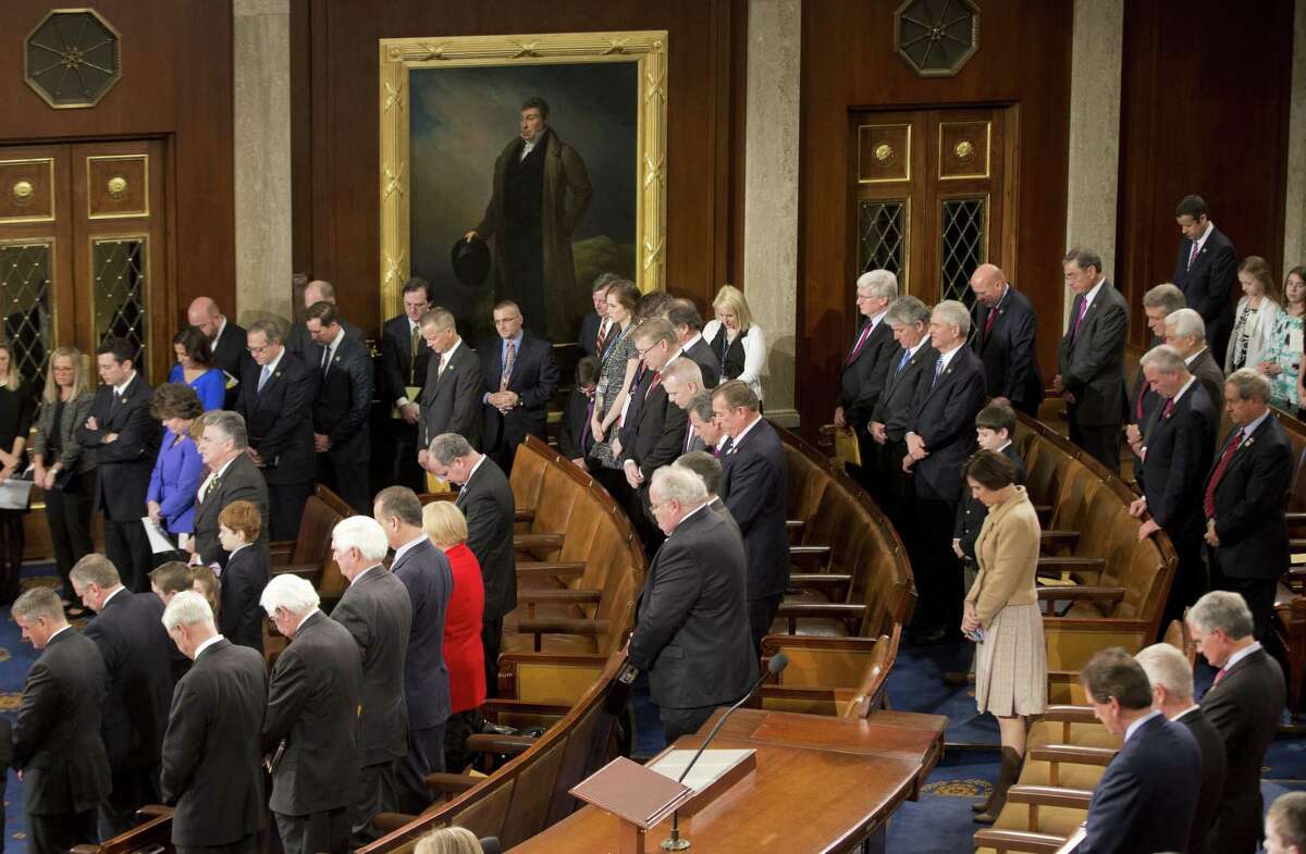 Members of the House of Representatives bow their heads during a prayer as they gather for opening session of the 114th Congress on Capitol Hill in Washington, Tuesday, Jan. 6, 2105, as Republicans assume full control. House Speaker John Boehner, R-Ohio, is expected to win a third despite a tea party-backed effort to unseat him, and Sen. Mitch McConnell, R-Ky., ascends to majority leader of the Senate after Democrats lost control the wake of November's midterm elections. (AP Photo/Pablo Martinez Monsivais )